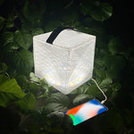 Load image into Gallery viewer, Bright and powerful MegaPuff lantern charging a phone in nature.