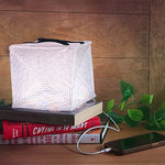 Load image into Gallery viewer, MEGAPUFF solar lantern on books charging iPhone with hybrid light setting
