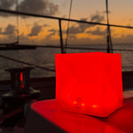 Load image into Gallery viewer, Red solar lantern on a boat for safety lighting.