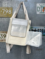 Load image into Gallery viewer, Backpack hanging from canvas straps with lantern attached.