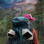 Load image into Gallery viewer, Camper carrying SolarPuff lanterns attached to backpack for off-grid lighting