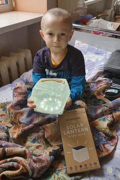 Child from Ukraine holding SolaPuff Lantern.