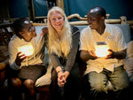 Load image into Gallery viewer, People holding solar lanterns and smiling.