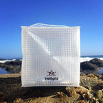 Load image into Gallery viewer, How happy does this make you fee? thiis solar lantern can go anywhere you do. it collapses flat and pops open into a happy cube of light. This shows solar lantern TWILIGHT on the ocean jetty. No fear it will get wet because it's waterproof and floats.