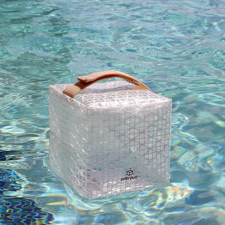 SolarPuff floating in pool showing waterproof outdoor light design