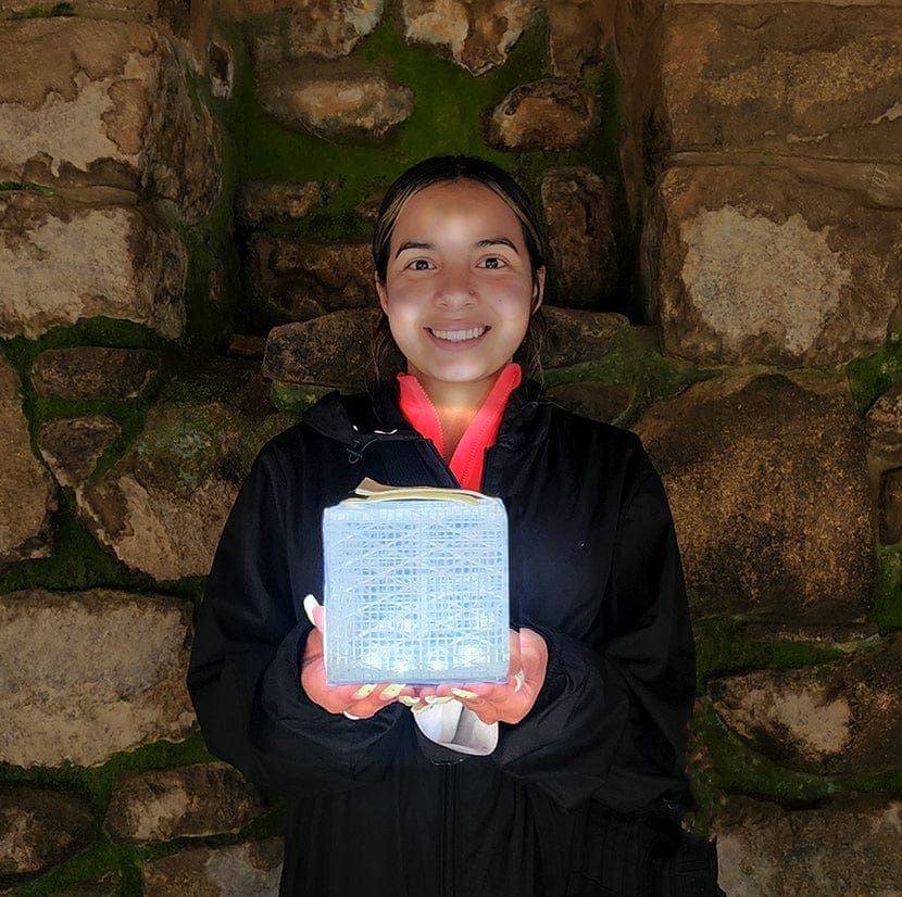 Young woman holding SolarPuff solar lantern.