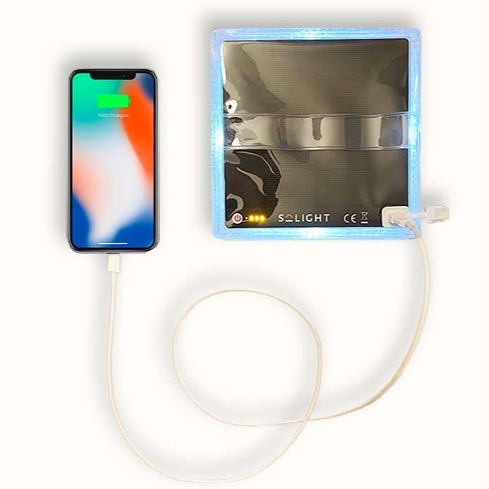 Top view of flat-packed MEGAPUFF solar charger powering a phone