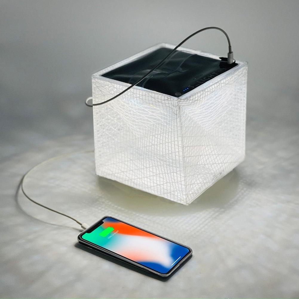 MEGAPUFF solar lantern charging iPhone with panel facing sunlight