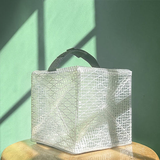 MEGAPUFF solar lantern on teal background displayed on chair