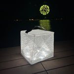 Load image into Gallery viewer, Solar lantern illuminating a dock with fireworks in the background.
