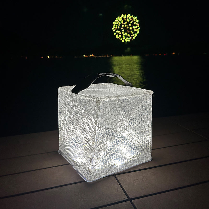 Solar lantern illuminating a dock with fireworks in the background.