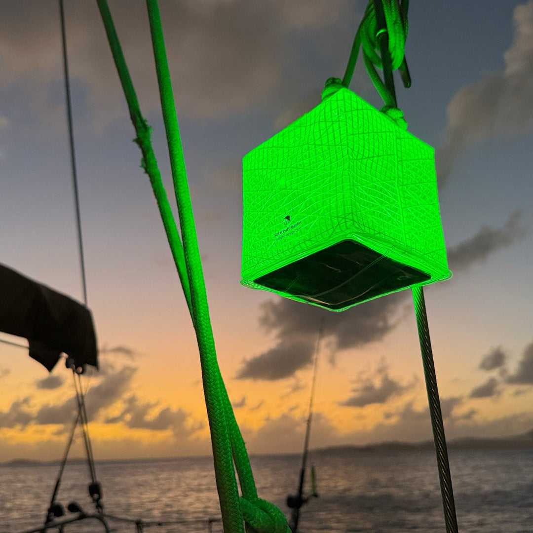 Bright green Solight solar lantern lighting a boat.