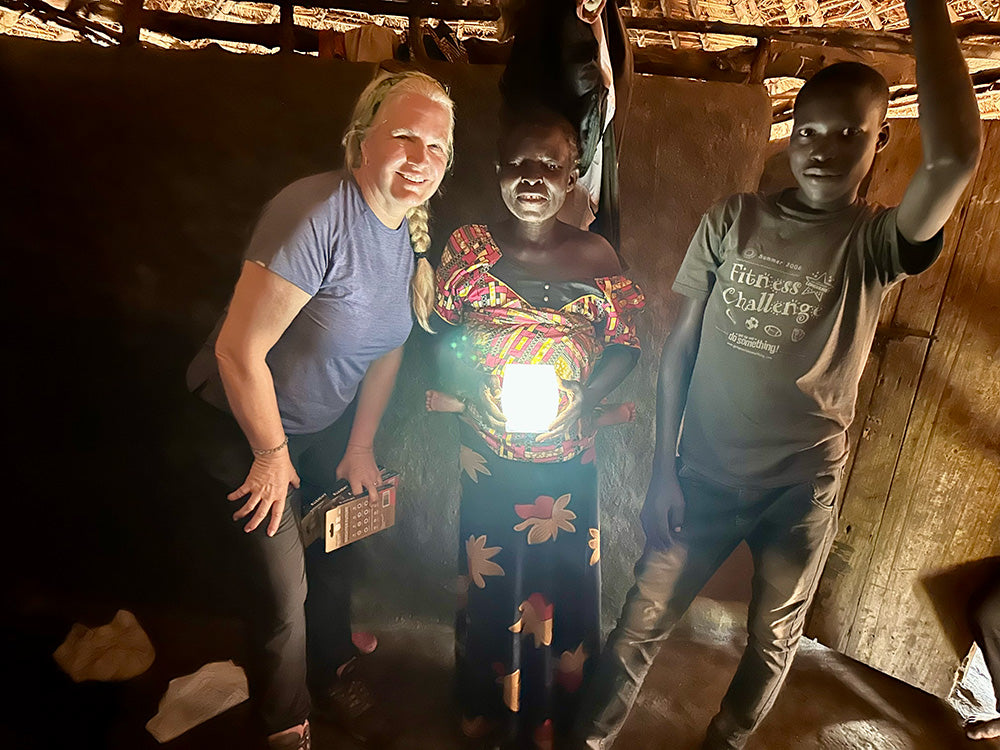 People in Uganda holding Solight lanterns.
