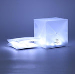 Load image into Gallery viewer, Solar-lantern-shows collapsed. and shows cube form two lights. One that is a flat square and one that is open in a perfect cube. Looks like an ice cube. Can be used-outdoor-indoor-garden-party-This shows the solar lantern flat packed and fully open in cube form, it&#39;s so modern you will want to keep it in yo.ur bedroom for bed side. reading.

