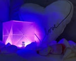 Load image into Gallery viewer, COLOR SOLAR LANTERNS - solar-lamp-outdoor-inddor-light- this shows the light on a couch with a pillow that is heart shaped and love is written on it.Multipacks solight2.myshopify.com
