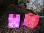 Load image into Gallery viewer, Colored Solar lantern for any hiking or camping trip shown here SolarPuff Multi-colored lamp on the rugged rocks of Bermuda.
