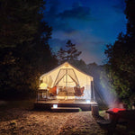 Load image into Gallery viewer, Helix Hybrid lantern in bright mode outside glamping tent for outdoor lighting
