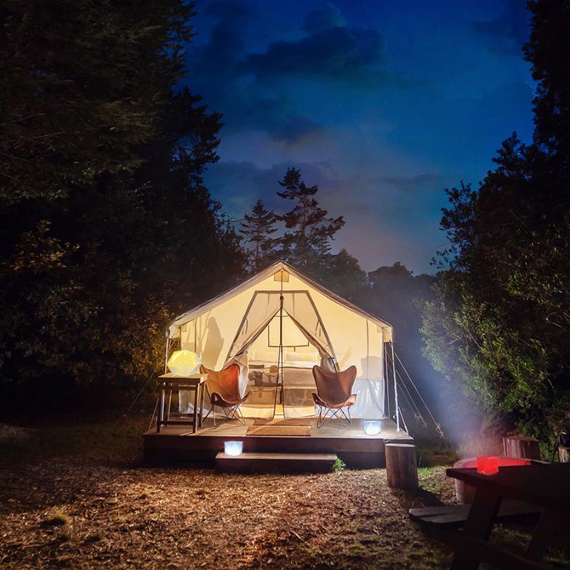 Helix Hybrid lantern in bright mode outside glamping tent for outdoor lighting