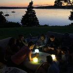 Load image into Gallery viewer, Group of friends using Helix Hybrid solar lanterns on patio at dusk for outdoor gathering
