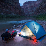 Load image into Gallery viewer, Helix Hybrid lantern outside a tent by the Grand Canyon river for wilderness lighting
