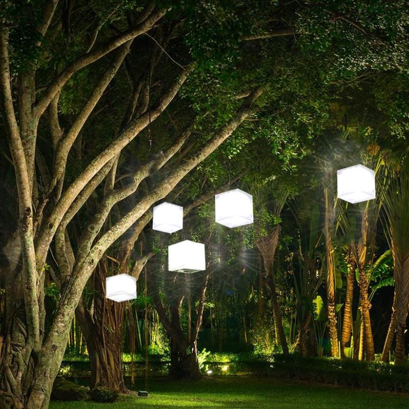 Helix Hybrid solar lanterns hanging in trees for ambient outdoor lighting