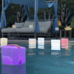 Load image into Gallery viewer, Floating pool lights showing multi-colored solarpuff in magenta light. beauty and function our origami lights are the best for solar lifestyles. 
