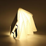Load image into Gallery viewer, QWNN lantern in folded night light mode with soft warm glow
