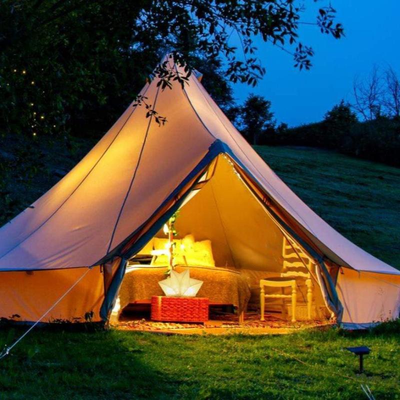 QWNN lantern illuminating interior of glamping tent with warm ambient light